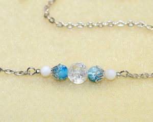 Elegant bar necklace with natural clear white crackle quartz, white mother of pearl shell, and speckled blue glass