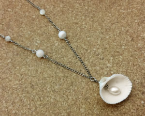 White necklace with shells and oval fresh water cultured pearl