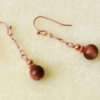 Photo of goldstone dangle earrings with bright copper chains and hooks