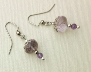 Delicate earrings with hand-cut faceted amethyst, silver-plated bead caps, and stainless steel hooks