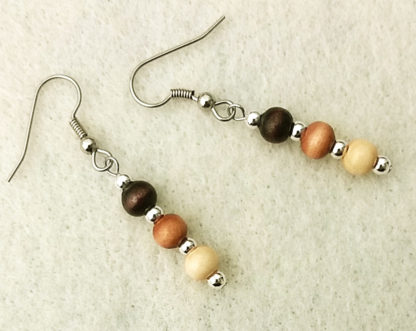 Photo of lightweight stick earrings with natural wooden beads of three different shades of brown by Motley Mix Jewelry