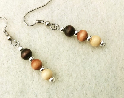 Photo of lightweight stick earrings with natural wooden beads of three different shades of brown by Motley Mix Jewelry