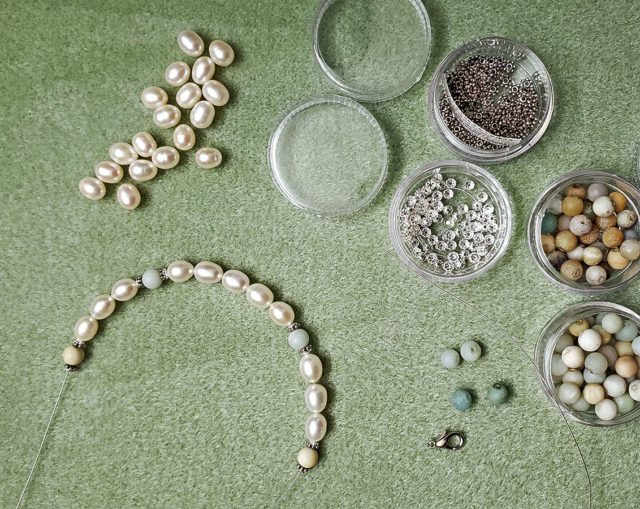 Photo of an unfinished custom necklace with vintage pearls and natural amazonite beads, work in progress