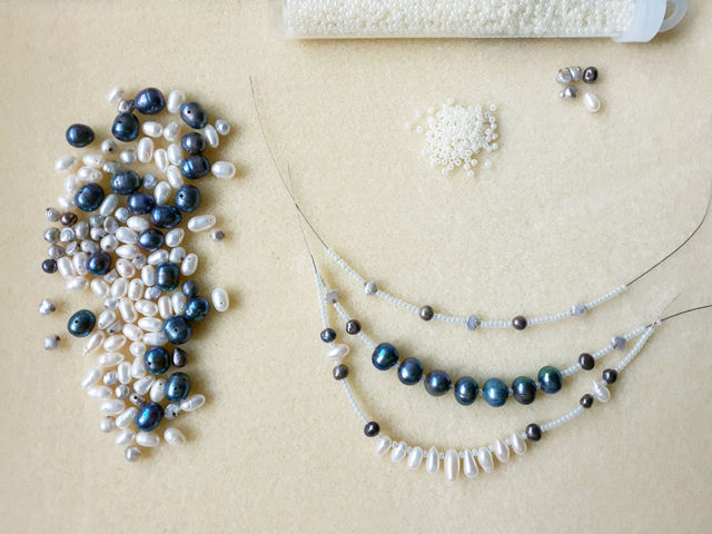 Photo of a beginning stage of the designing a multi strand necklace with vintage fresh water pearls of different shapes and colors ~ work in progress ~ Motley Mix Jewelry